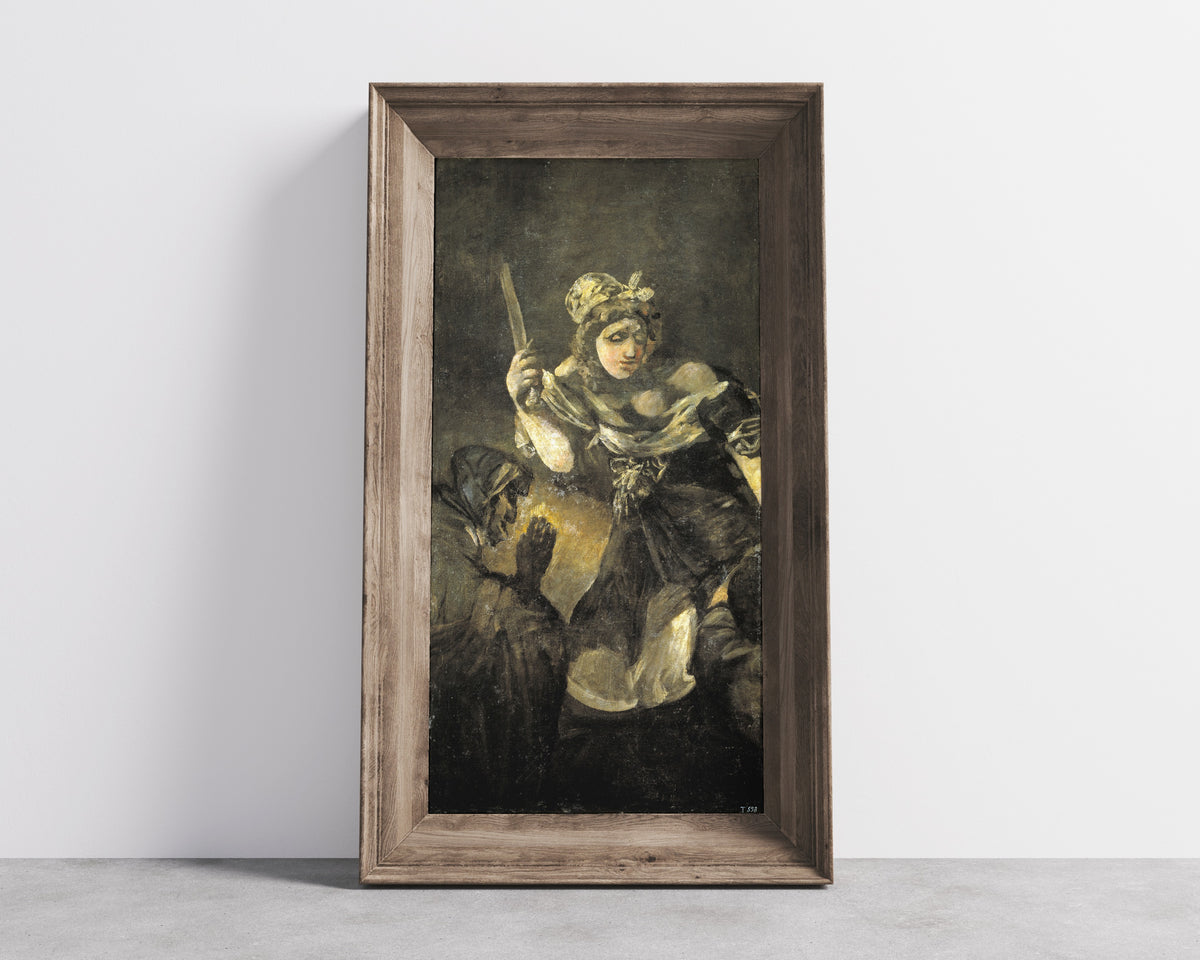 Framed art print of Judith and Holofernes by Francisco de Goya, in a wide wooden frame leaning against a concrete wall