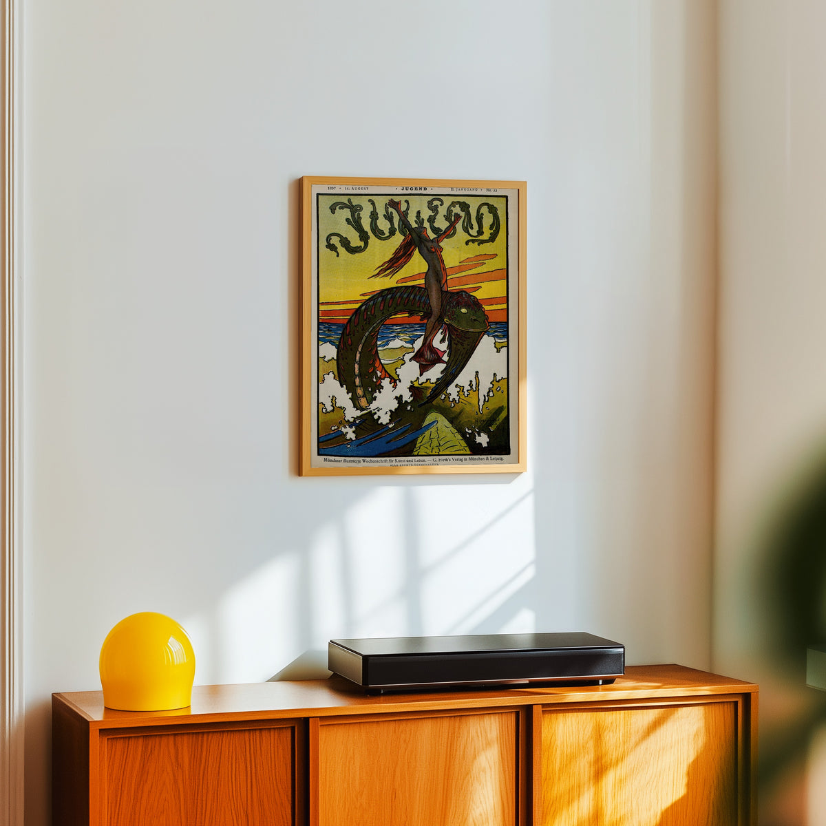 Framed art print of Jugend, No. 33 by Hans Christiansen, in a light wood frame on a white wall above an orange sideboard