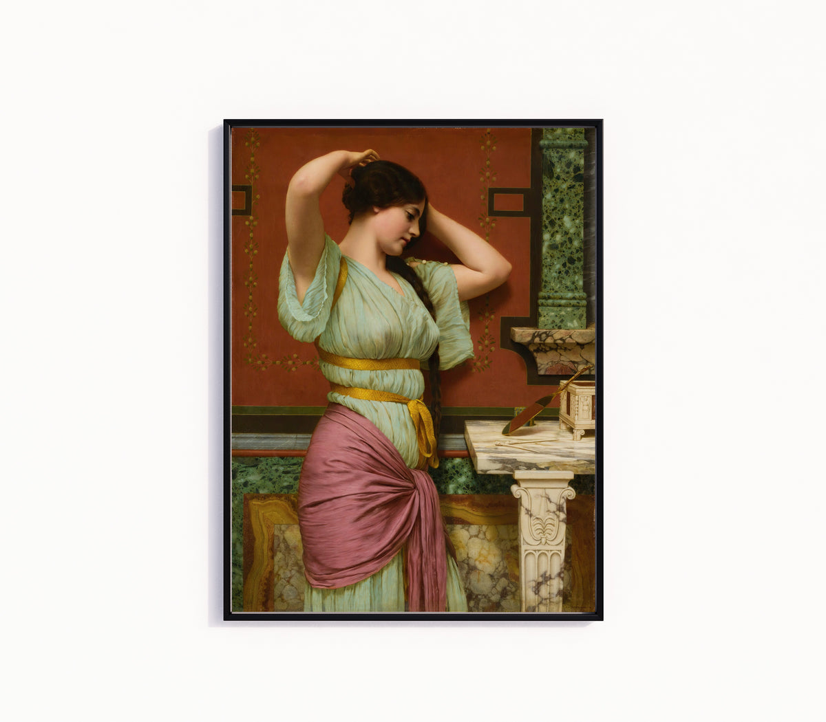 Framed art print of Julia by John William Godward, in a slim black frame on a plain white wall