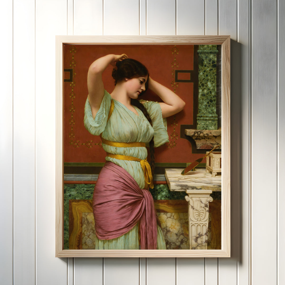 Framed art print of Julia by John William Godward, in a light wood frame on a white panelled wall
