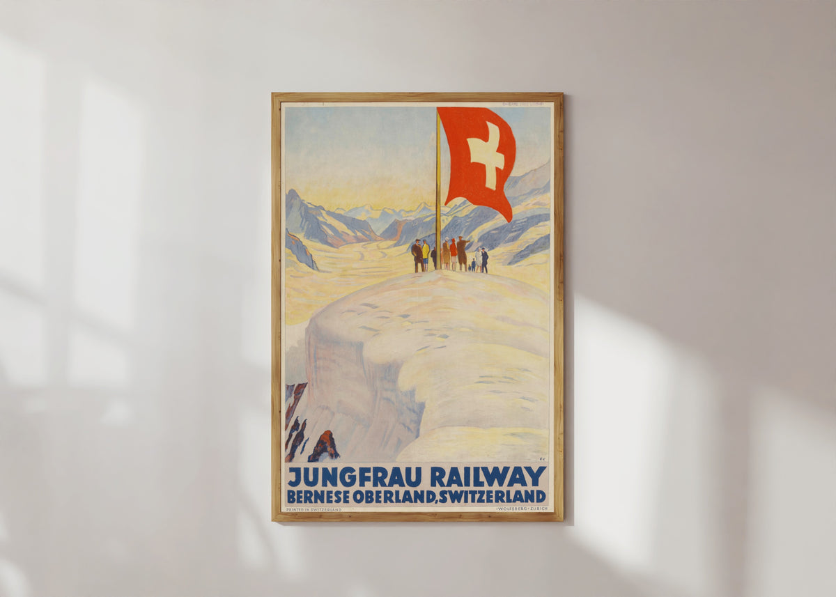 Framed art print of Jungfrau Railway: Bernese Oberland, Switzerland by Emil Cardinaux, in a light wood frame on a sunlit white wall