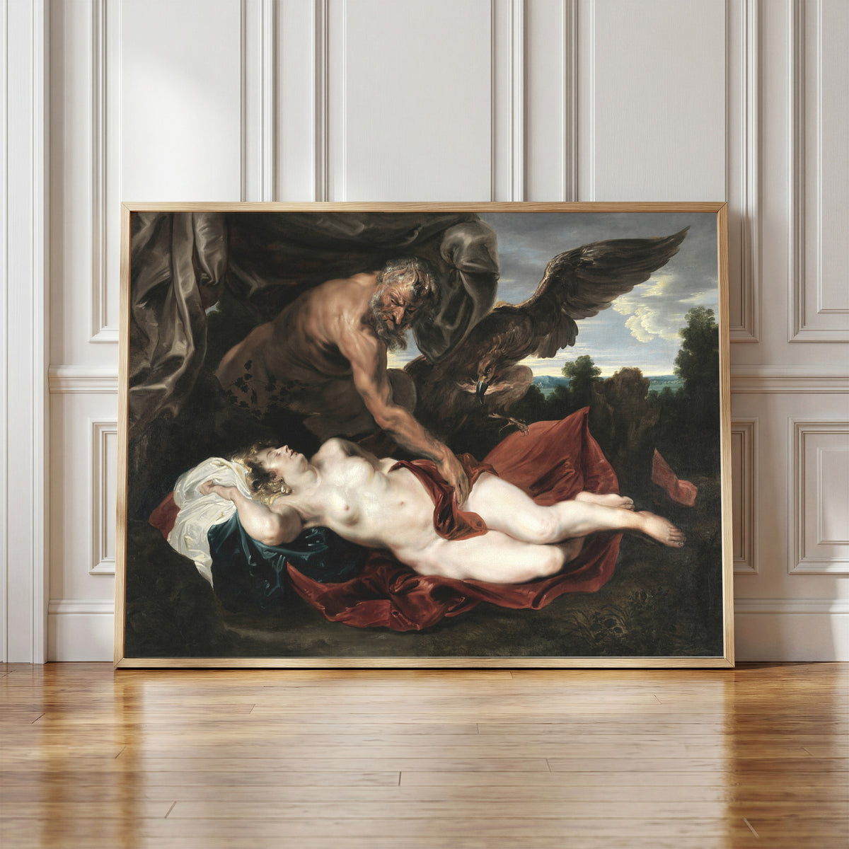 Framed art print of Jupiter and Antiope by Anthony van Dyck, in a light wood frame leaning against a panelled white wall