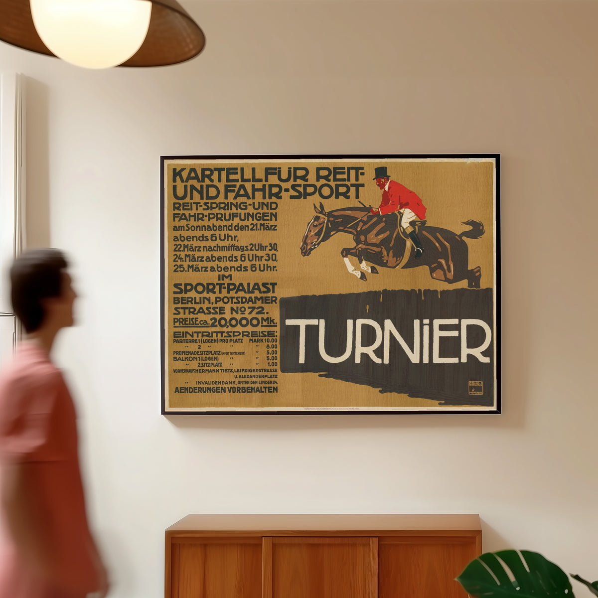 Framed art print of Kartell für Reit- und Fahr-Sport: Turnier by Ludwig Hohlwein, in a slim black frame on a warm wall in a sunlit room