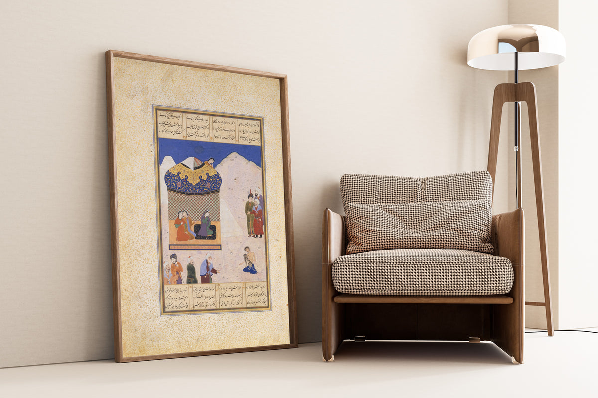 Framed art print of Khamsa of Amir Khusrau Dihlavi: Laila Visiting Majnun in the Desert, leaning against a wall beside an armchair and a floor lamp