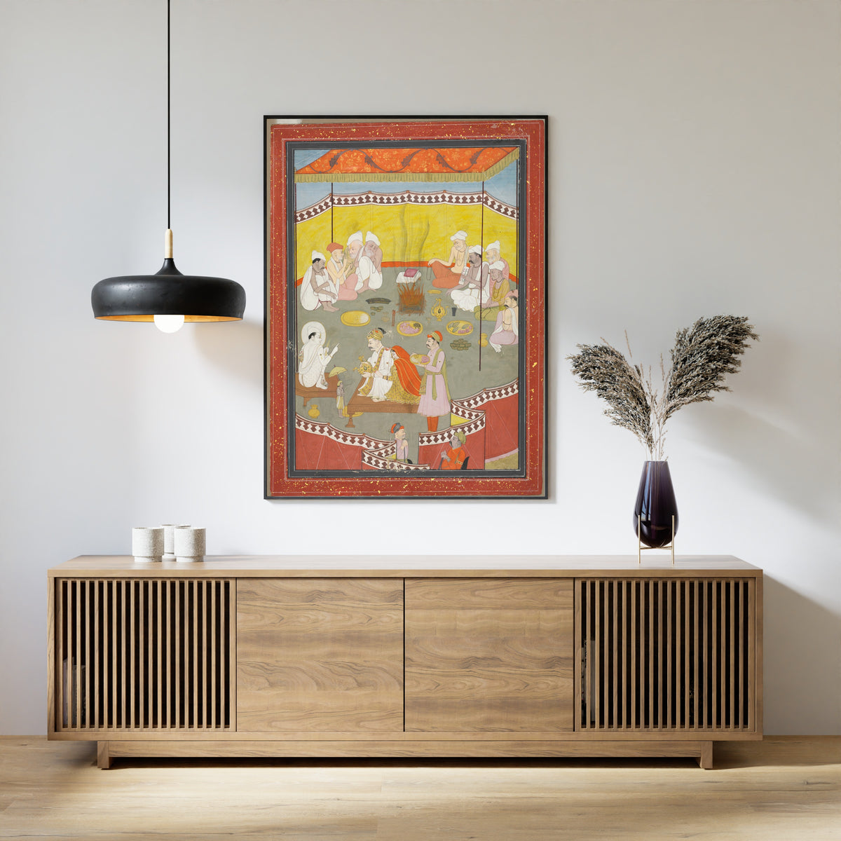 Framed art print of King Bali Gives a Gift of Land to Vamana by Pahari school, above a slatted wood sideboard