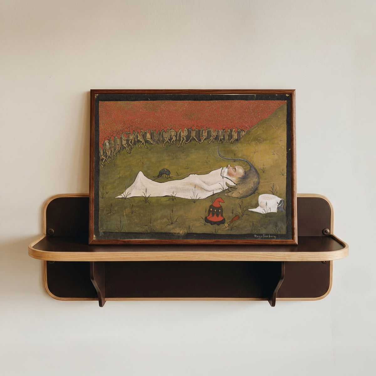 Framed art print of King Hobgoblin Sleeping by Hugo Simberg, in a dark wood frame resting on a wall shelf
