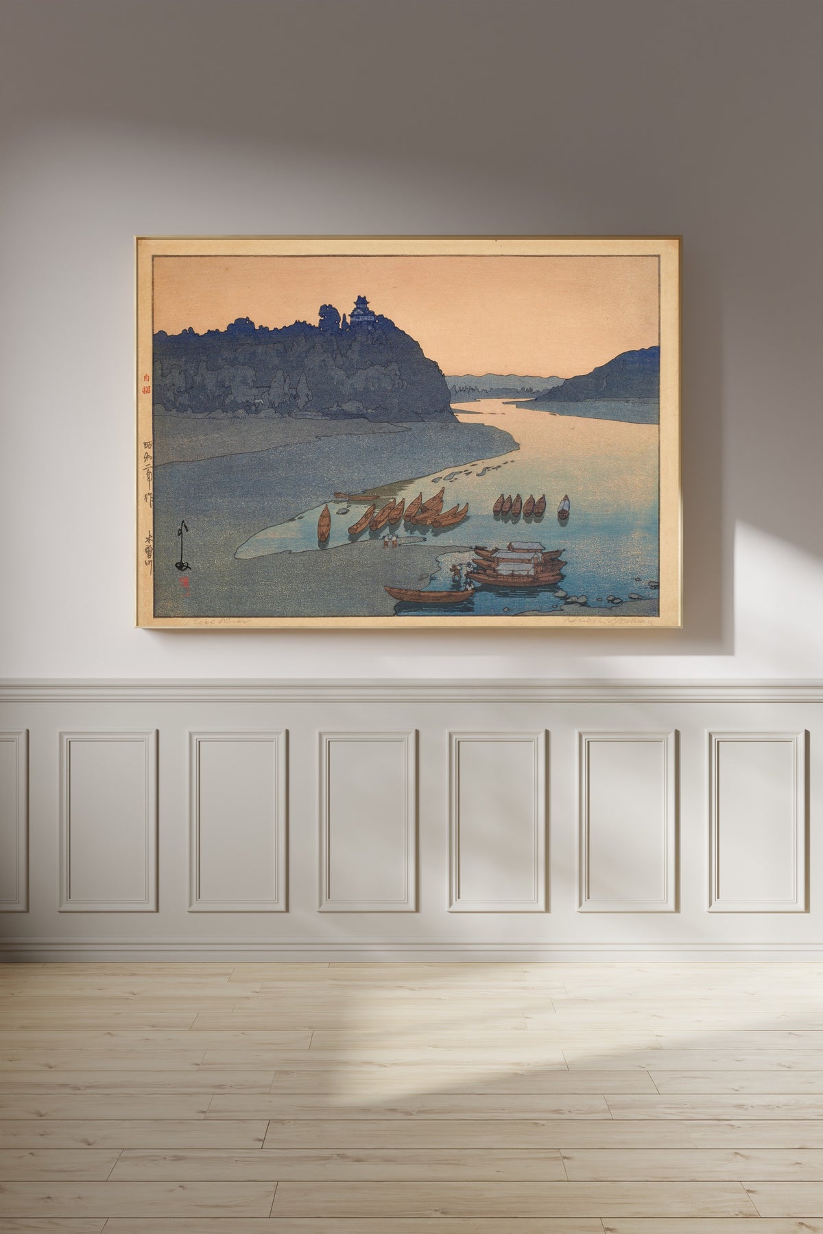 Framed art print of Kiso River by Hiroshi Yoshida, on a panelled wall in afternoon light