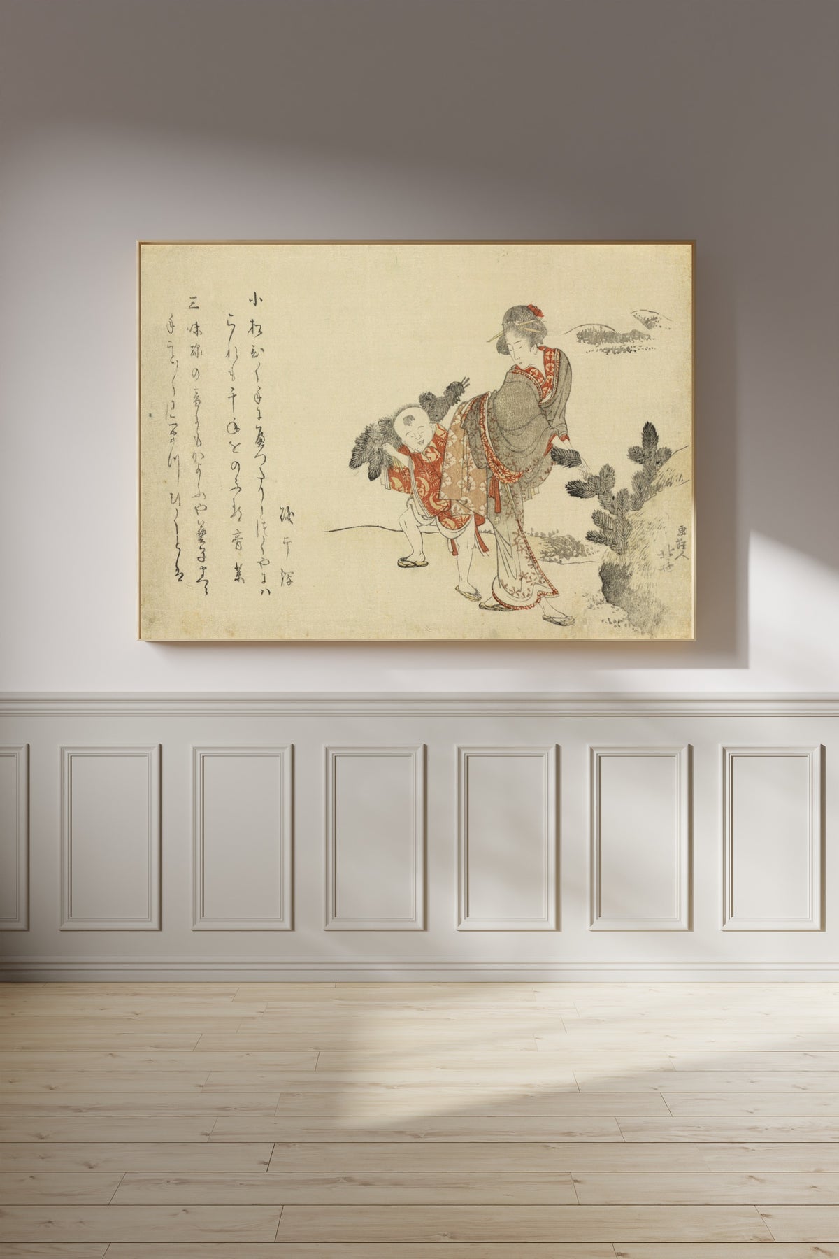Framed art print of Komatsubiki by Katsushika Hokusai, on a panelled wall in afternoon light