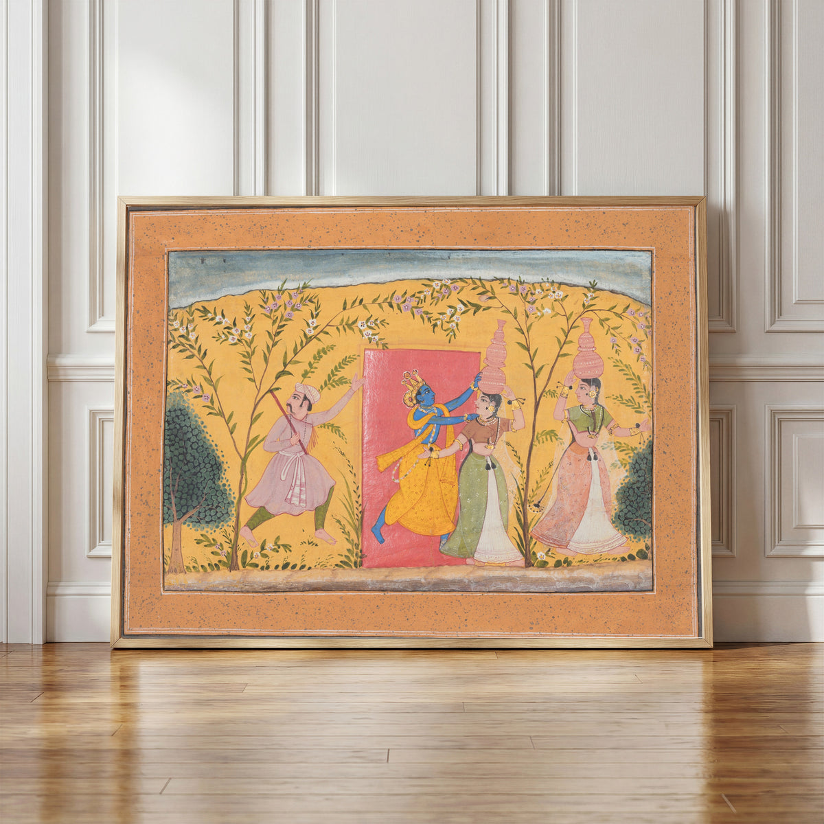 Framed art print of Krishna Exacts a Toll from the Milkmaids by Bikaner school, in a light wood frame leaning against a panelled white wall