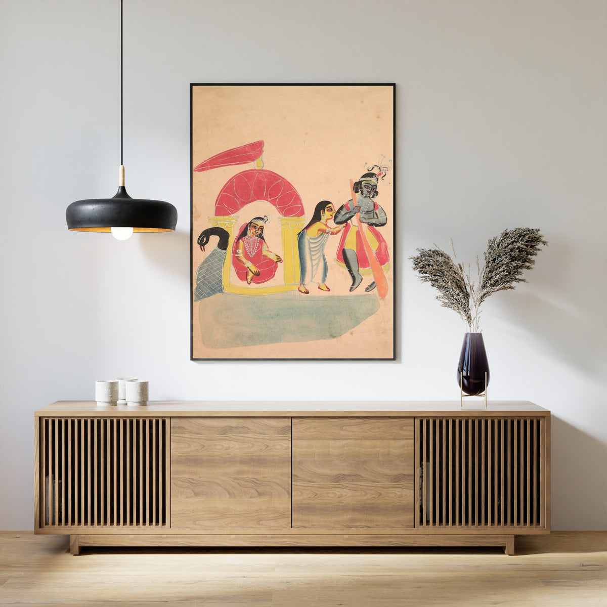 Framed art print of Krishna Ferrying Radha Across the Yamuna River by Kalighat painter, above a slatted wood sideboard