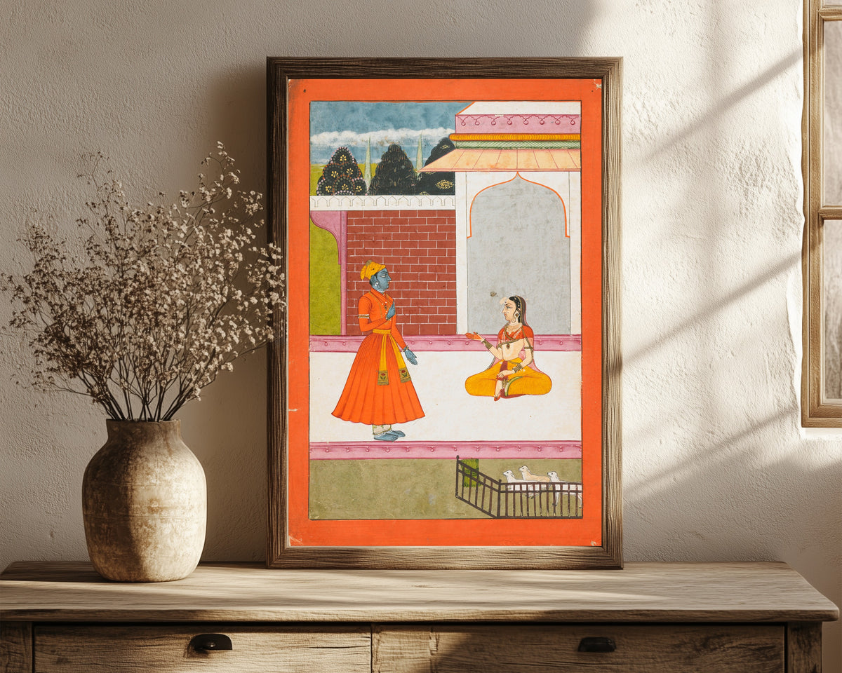 Framed art print of Krishna and Radha by Bikaner school, in a dark wood frame leaning on a rustic console beside dried flowers