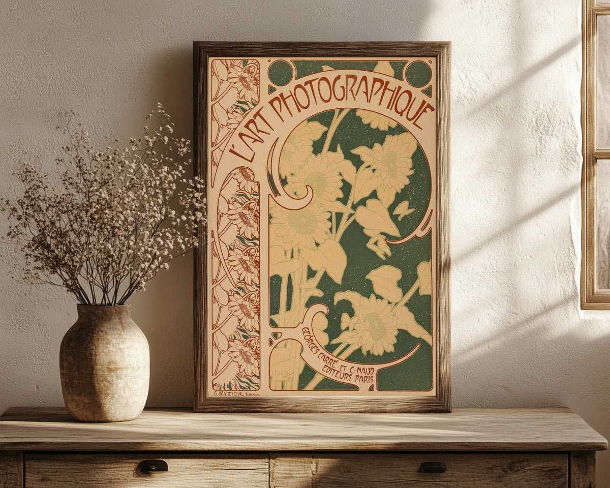 Framed art print of L’Art Photographique, no. 10 (cover) by Alphonse Mucha, in a dark wood frame leaning on a rustic console beside dried flowers