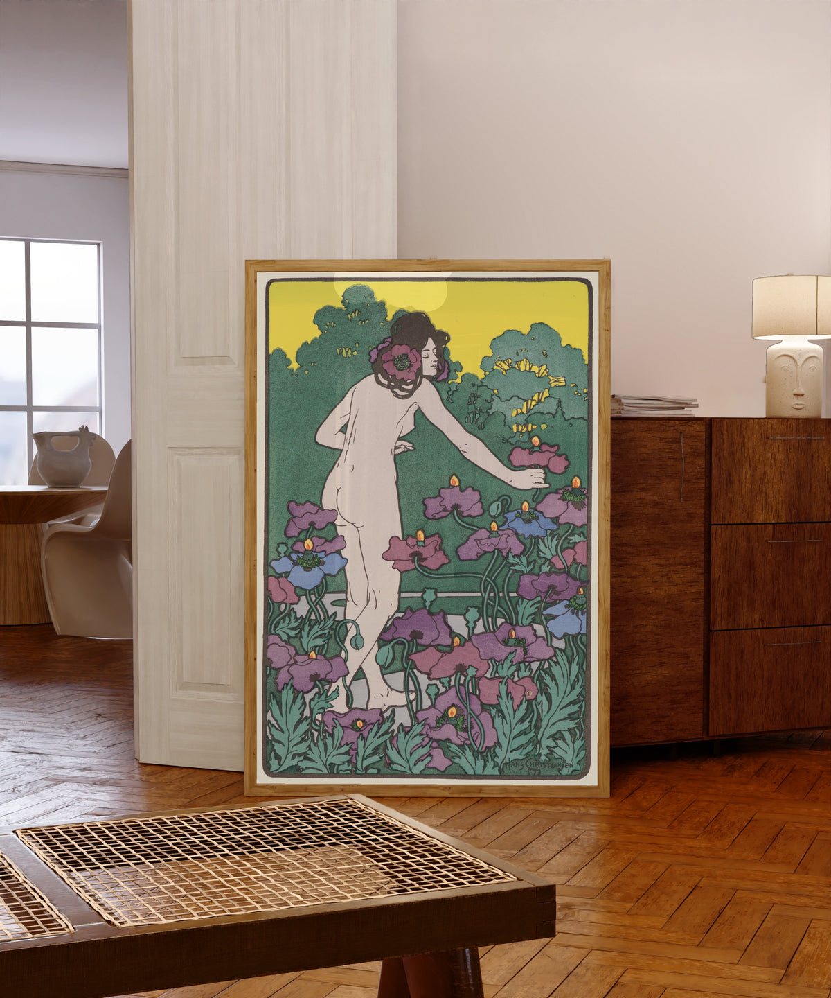 Framed art print of L'Heure du Berger by Hans Christiansen, in a light wood frame leaning in a warm room with a parquet floor