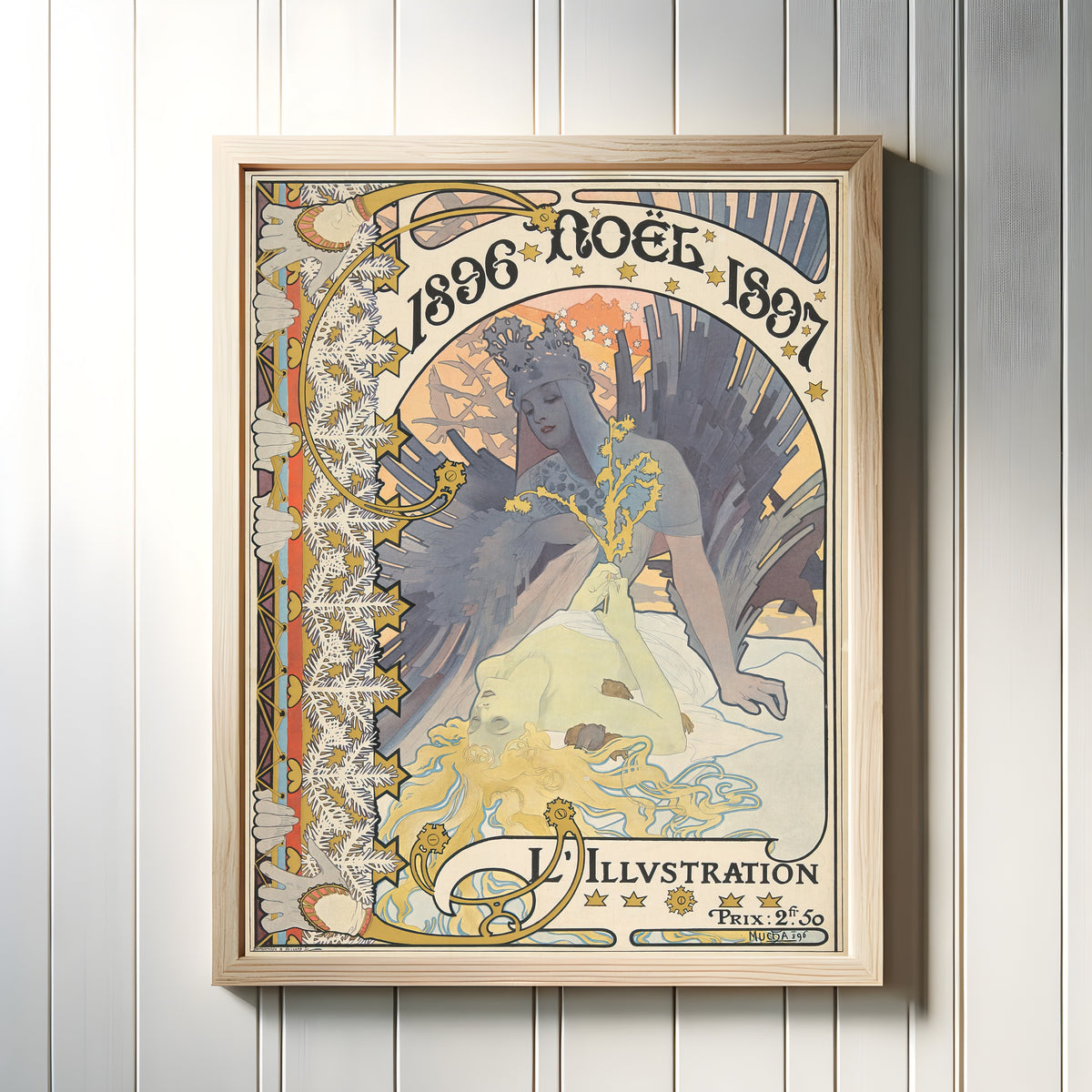 Framed art print of L’Illustration, Noël 1896-1897 by Alphonse Mucha, in a light wood frame on a white panelled wall