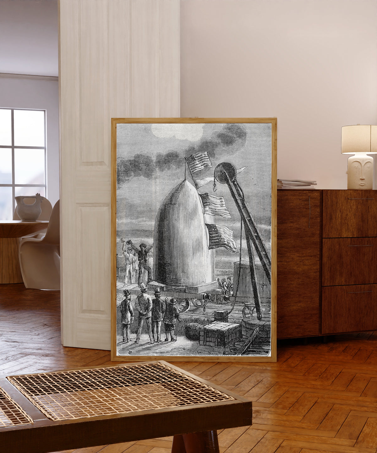 Framed art print of L'arrivée du projectile à Stone's-Hill (The… by Henri de Montaut, in a light wood frame leaning in a warm room with a parquet floor