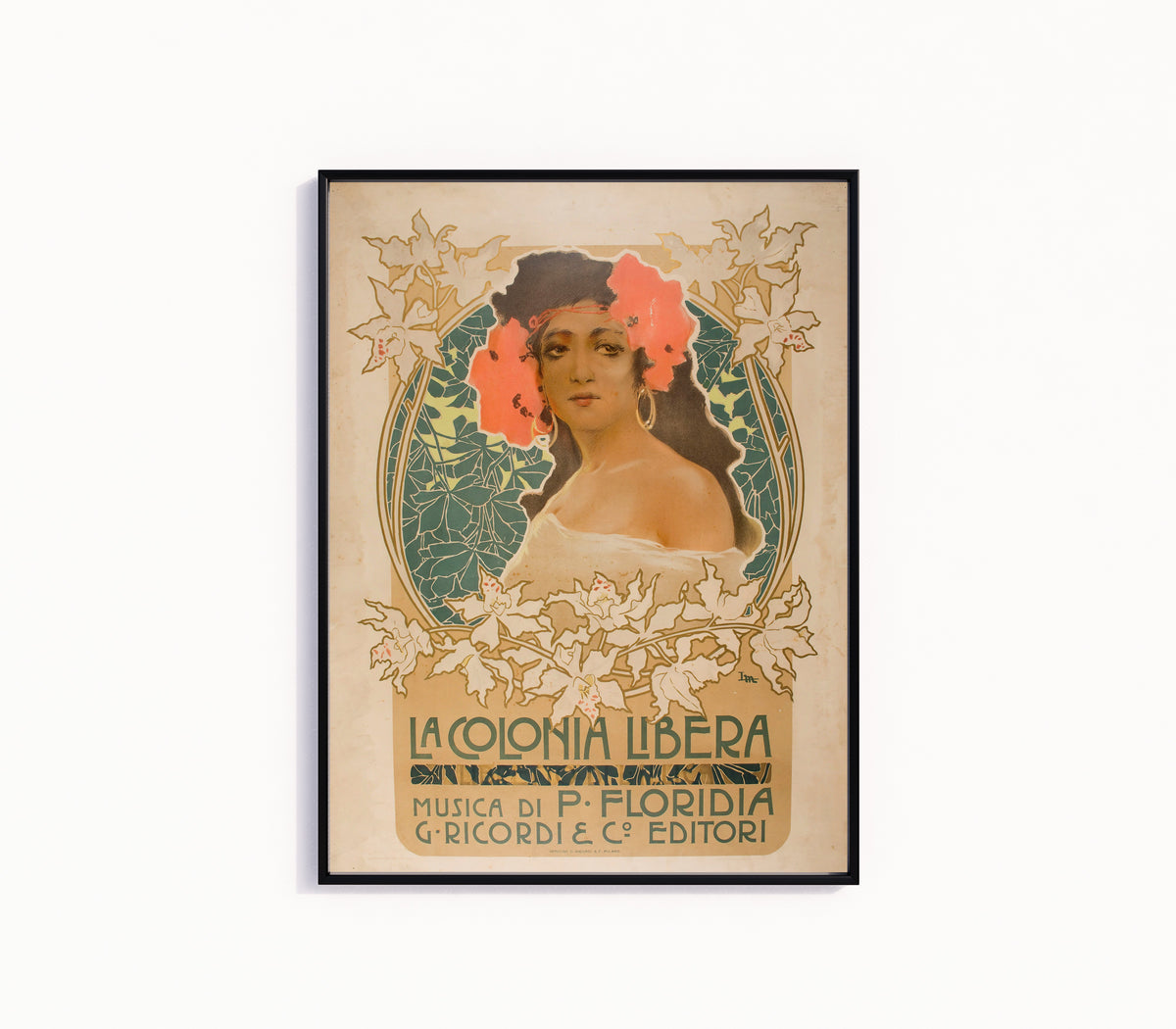 Framed art print of La Colonia Libera by Leopoldo Metlicovitz, in a slim black frame on a plain white wall