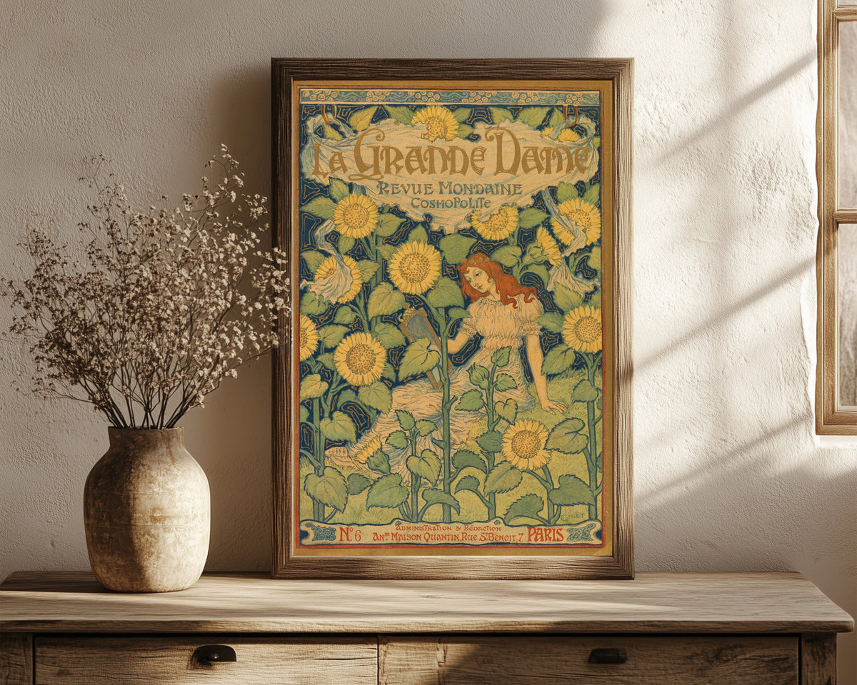 Framed art print of La Grande Dame by Eugène Grasset, in a dark wood frame leaning on a rustic console beside dried flowers