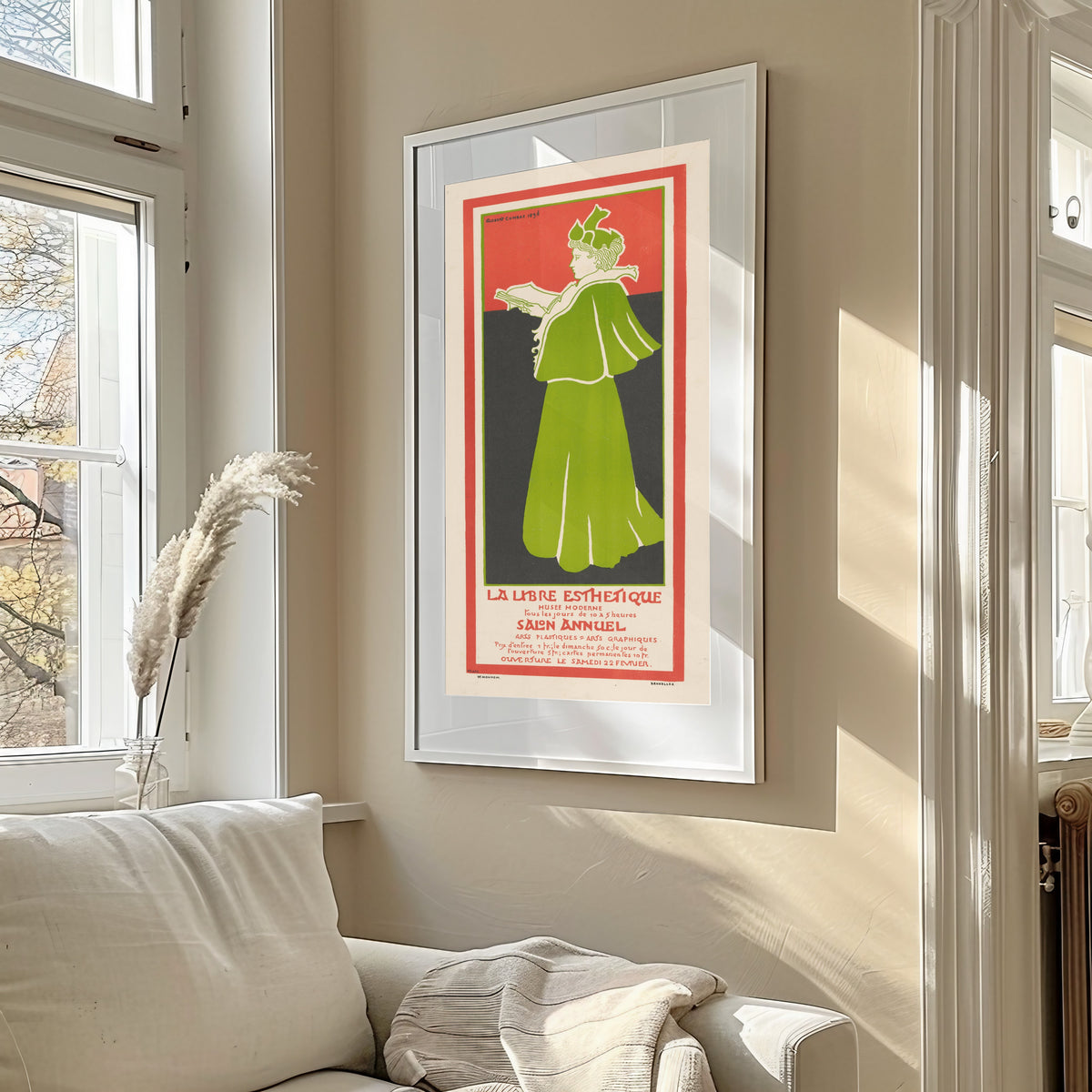 Framed art print of La Libre Esthétique, Salon Annuel (1896) by Gisbert Combaz, in a sunlit living room above a sofa