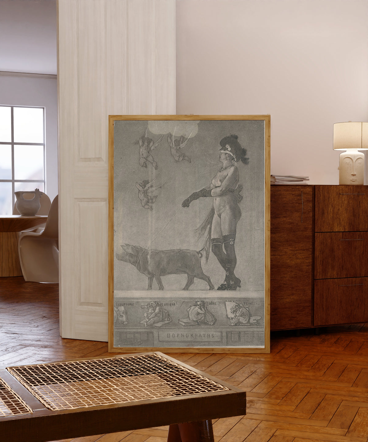Framed art print of La dame au cochon (2nd state) by Félicien Rops, in a light wood frame leaning in a warm room with a parquet floor