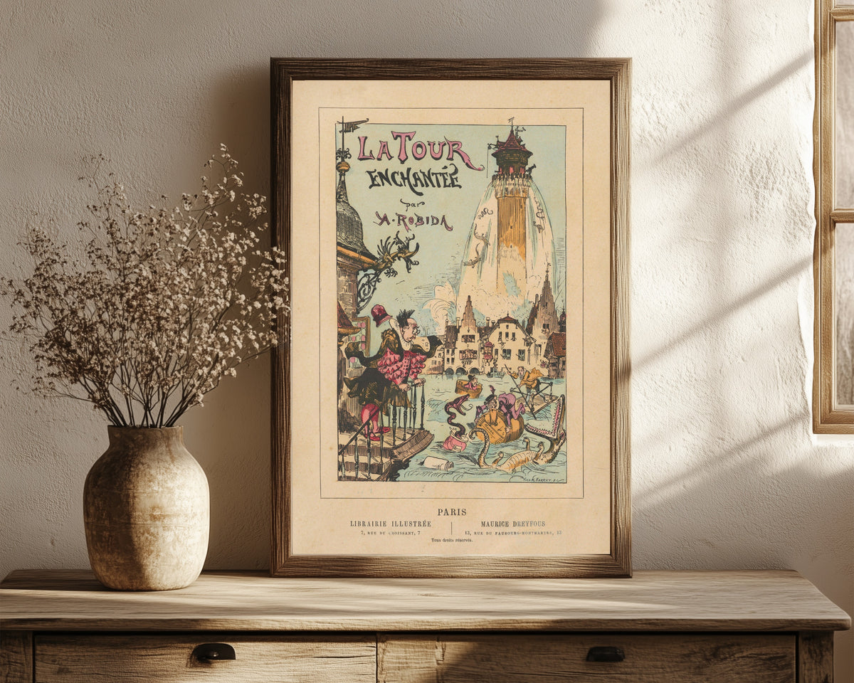 Framed art print of La tour enchantée- Titlepage by Albert Robida, in a dark wood frame leaning on a rustic console beside dried flowers