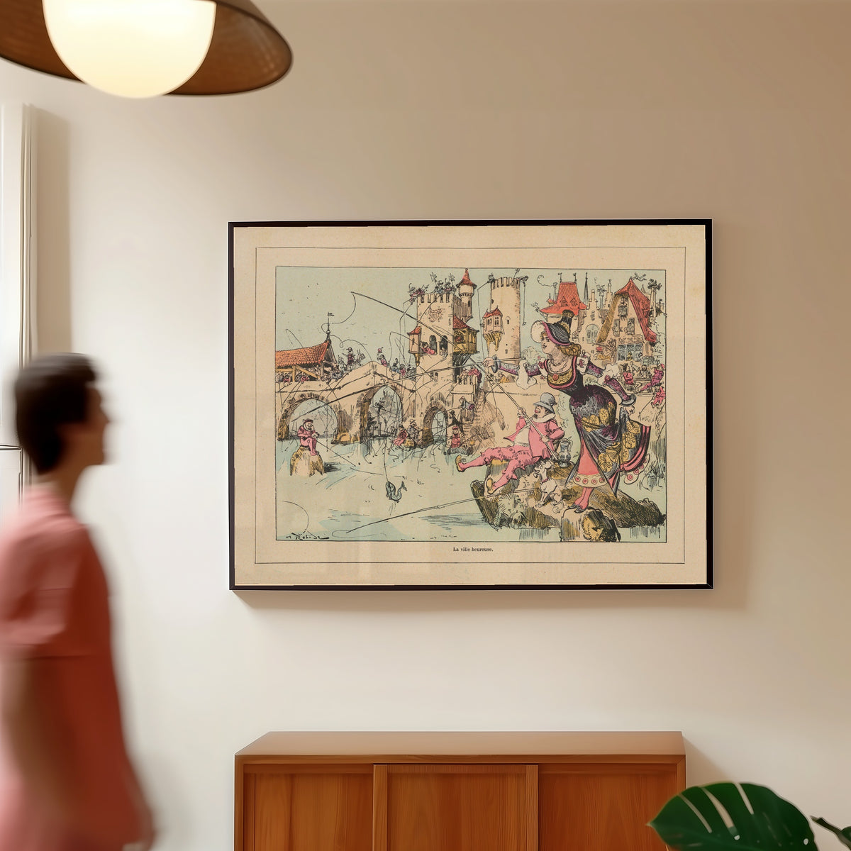 Framed art print of La ville heureuse by Albert Robida, in a slim black frame on a warm wall in a sunlit room