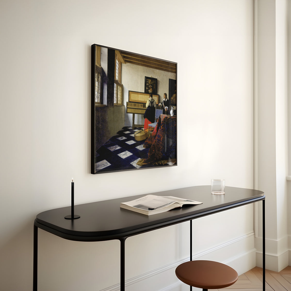 Framed art print of Lady at the Virginal with a Gentleman, ‘The Music Lesson’ by Johannes Vermeer, above a slim black console table
