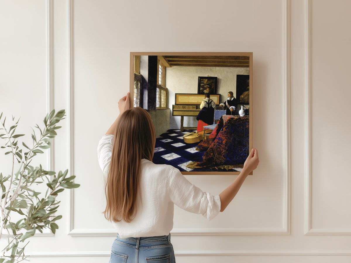 Framed art print of Lady at the Virginal with a Gentleman, ‘The Music Lesson’ by Johannes Vermeer, hung on a panelled wall