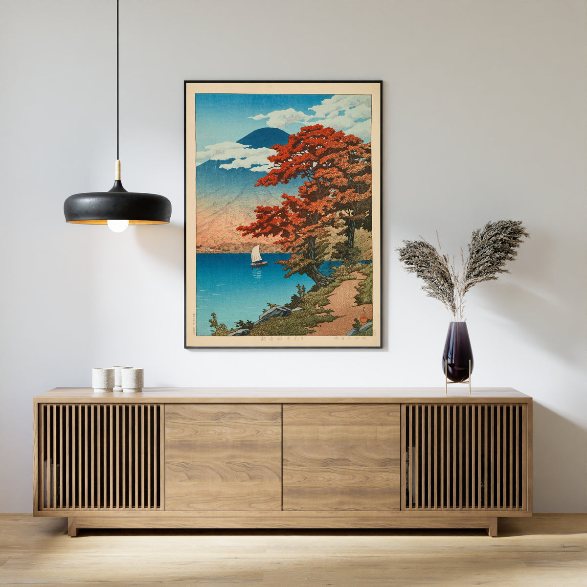 Framed art print of Lake Chuzenji at Nikko by Kawase Hasui, above a slatted wood sideboard