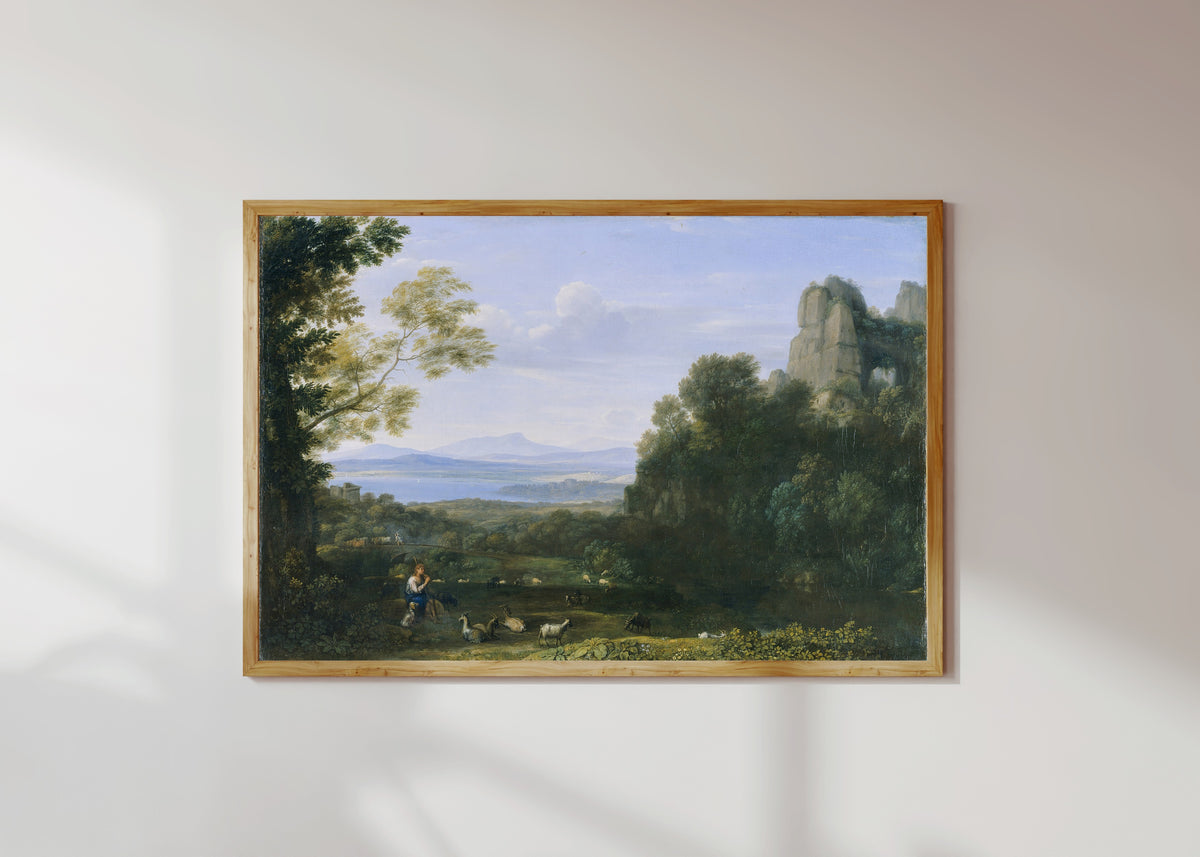 Framed art print of Landscape with Apollo and Mercury by Claude Lorrain, in a light wood frame on a sunlit white wall