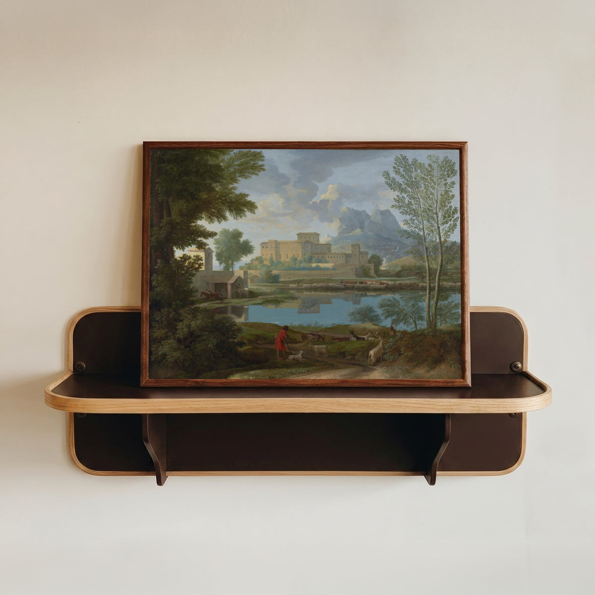 Framed art print of Landscape with a Calm by Nicolas Poussin, in a dark wood frame resting on a wall shelf