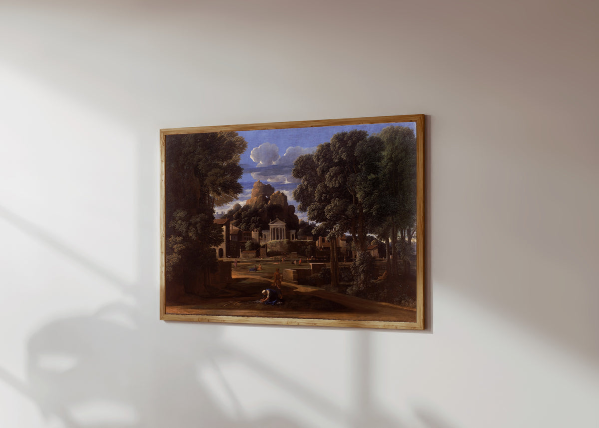 Framed art print of Landscape with the Ashes of Phocion by Nicolas Poussin, in a light wood frame on a sunlit white wall, seen at a slight angle