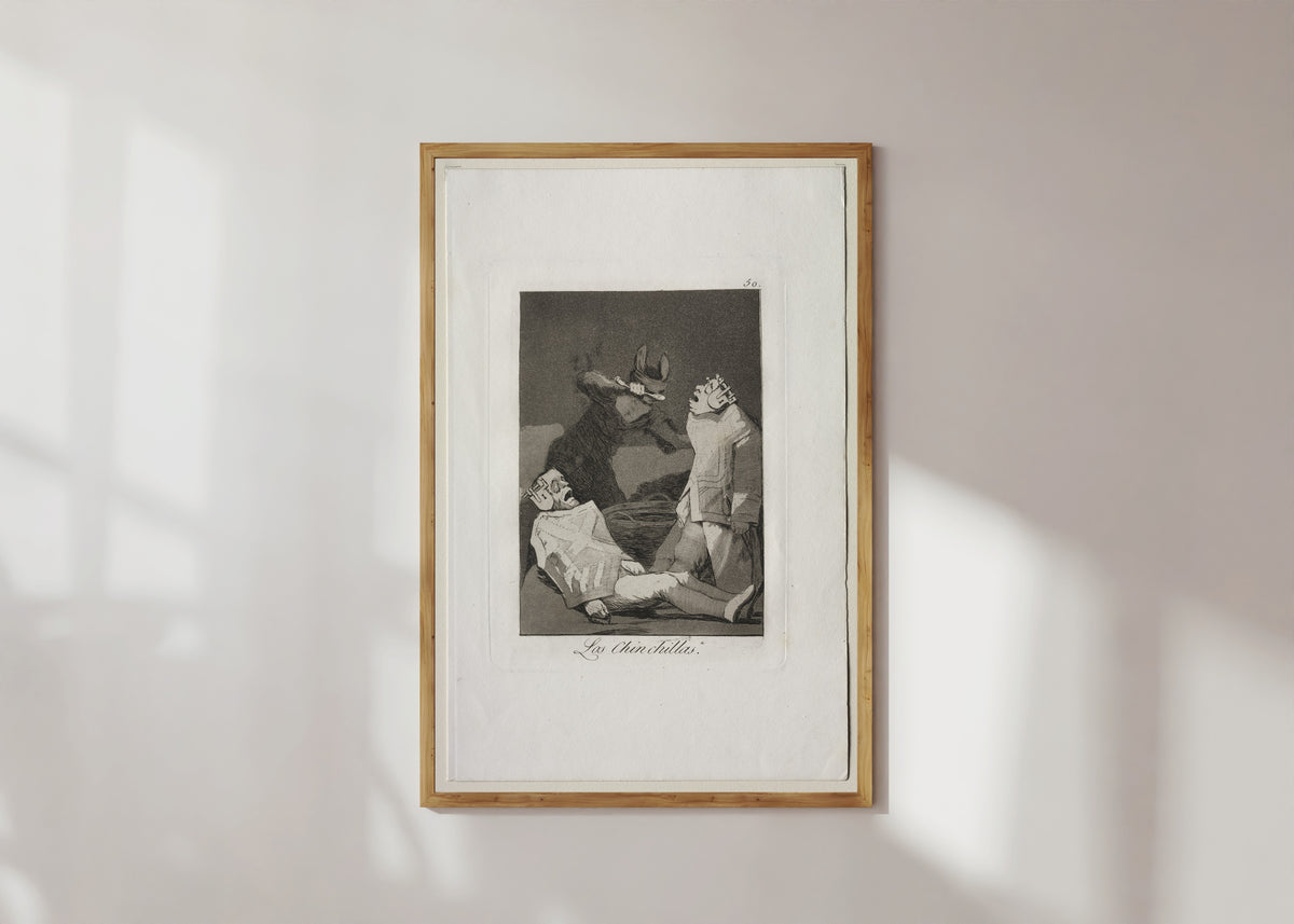 Framed art print of Las Chinchillas, Los Caprichos, Plate 50 by Francisco de Goya, in a light wood frame on a sunlit white wall