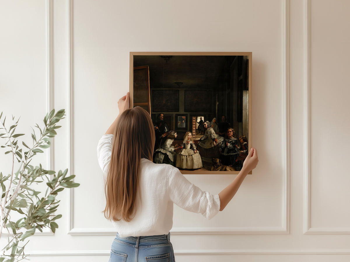Framed art print of Las Meninas by Diego Velázquez, hung on a panelled wall