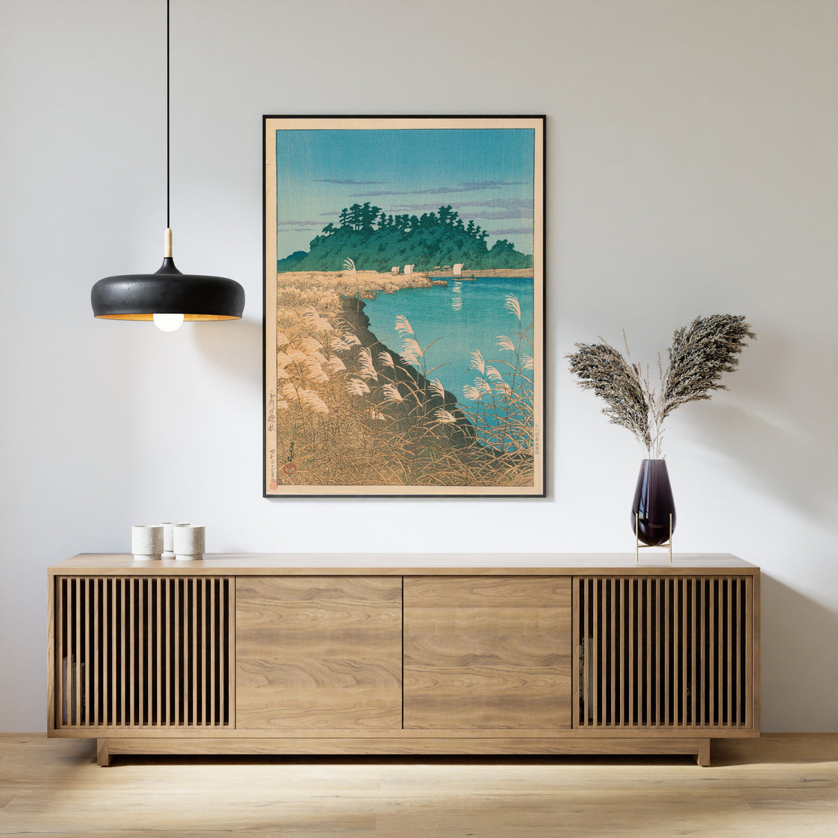 Framed art print of Late Autumn in Ichikawa by Kawase Hasui, above a slatted wood sideboard