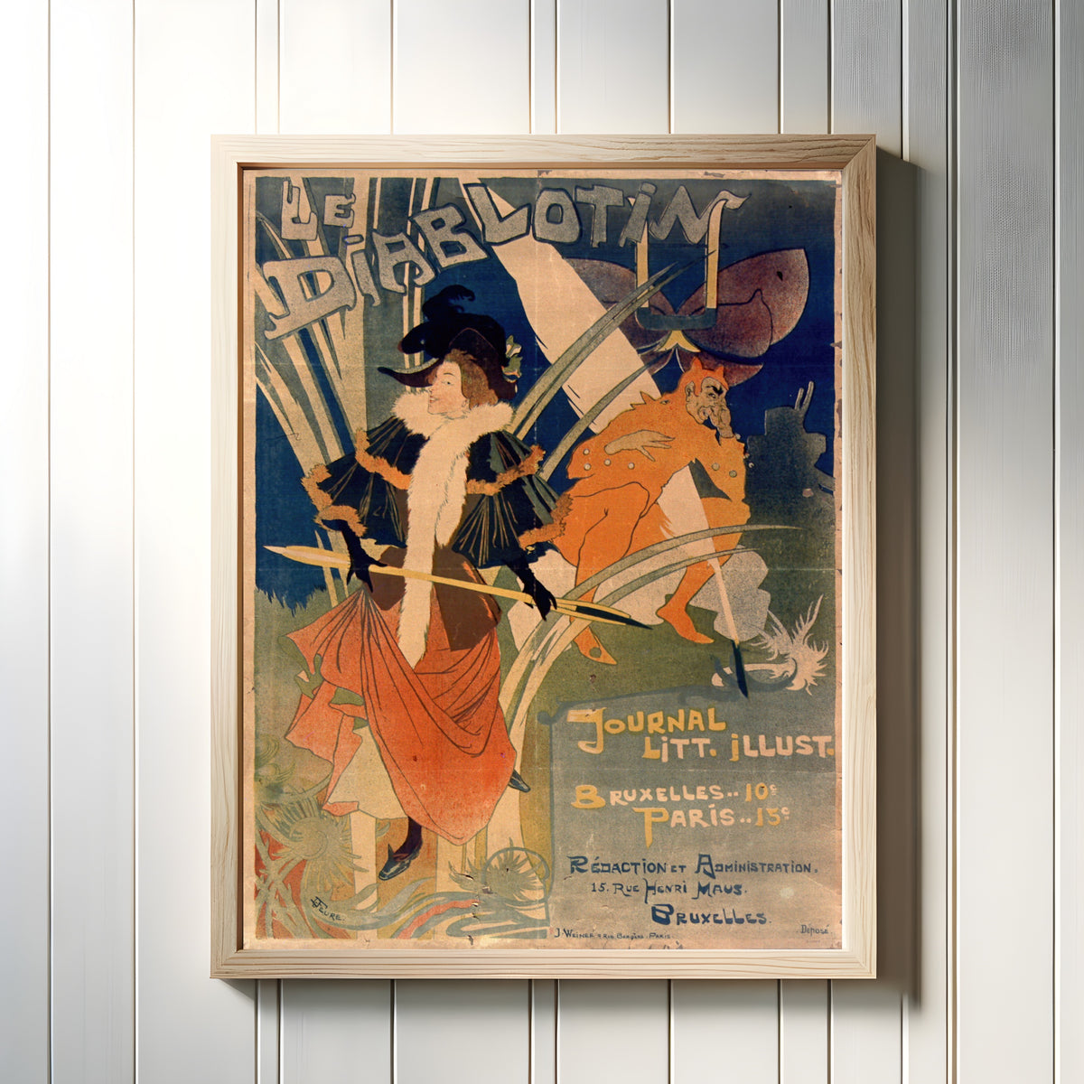 Framed art print of Le Diablotin by Georges de Feure, in a light wood frame on a white panelled wall
