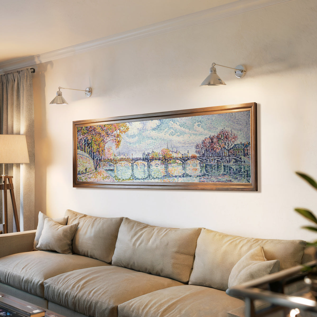 Framed art print of Le Pont des Arts (1928) by Paul Signac, above a long sofa with wall lights