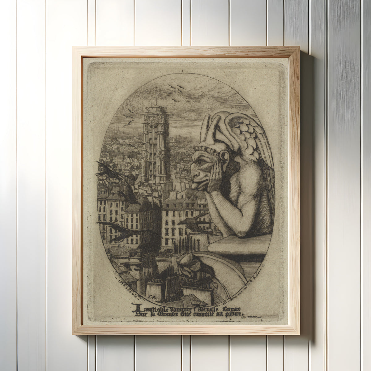 Framed art print of Le Stryge (The Vampire) by Charles Meryon, in a light wood frame on a white panelled wall