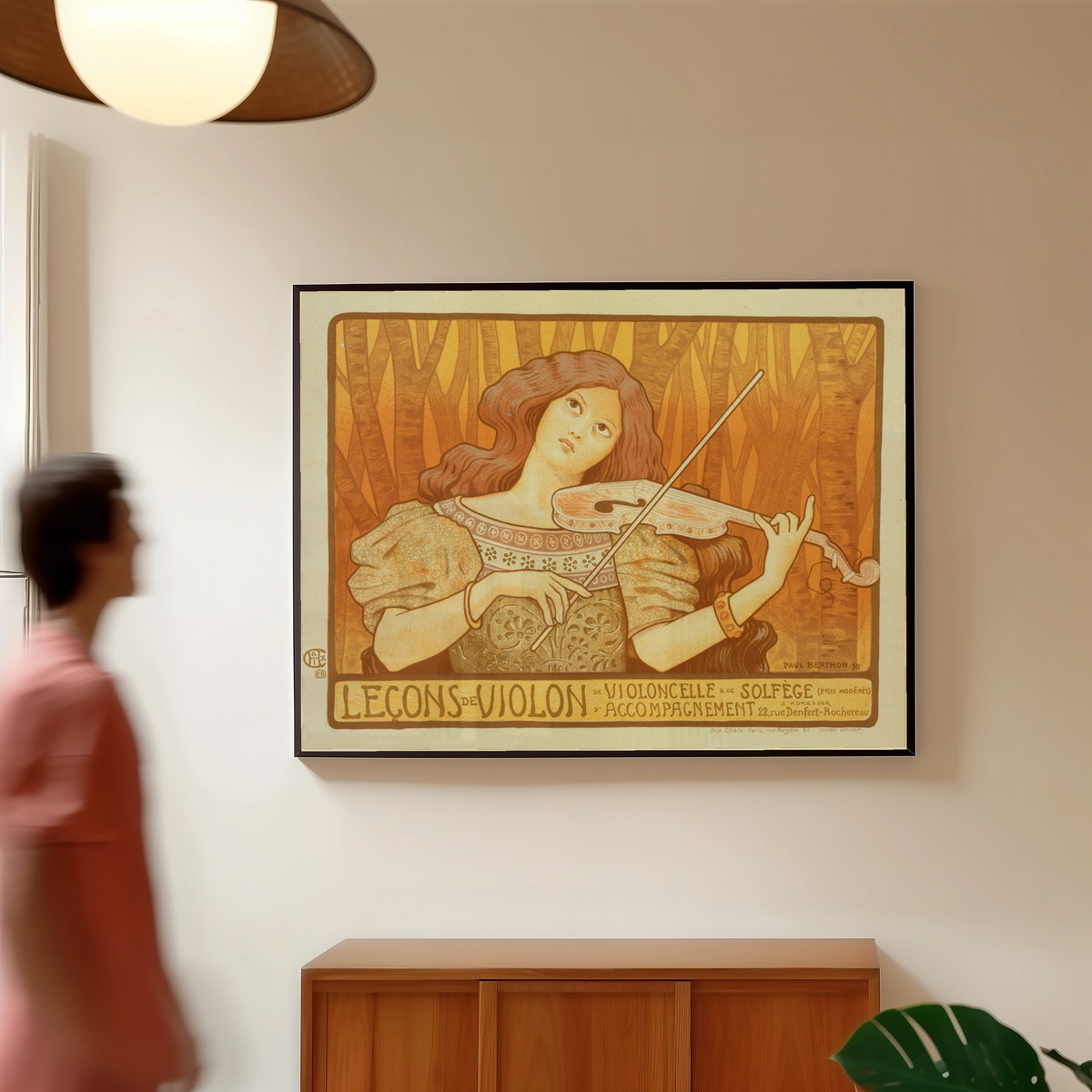Framed art print of Leçons de Violon by Paul Berthon, in a slim black frame on a warm wall in a sunlit room