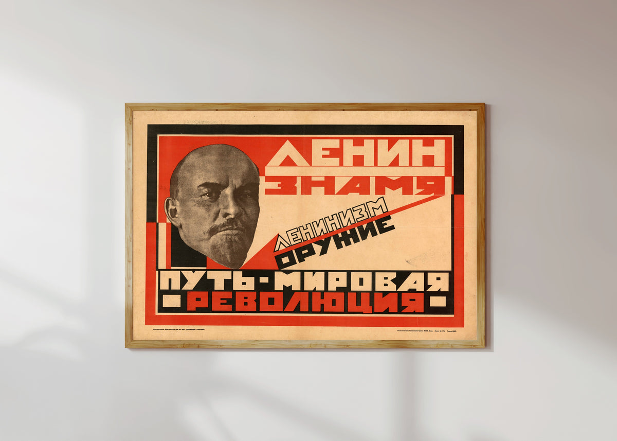 Framed art print of Lenin is the banner. Leninism is the weapon. The path is world revolution, in a light wood frame on a sunlit white wall