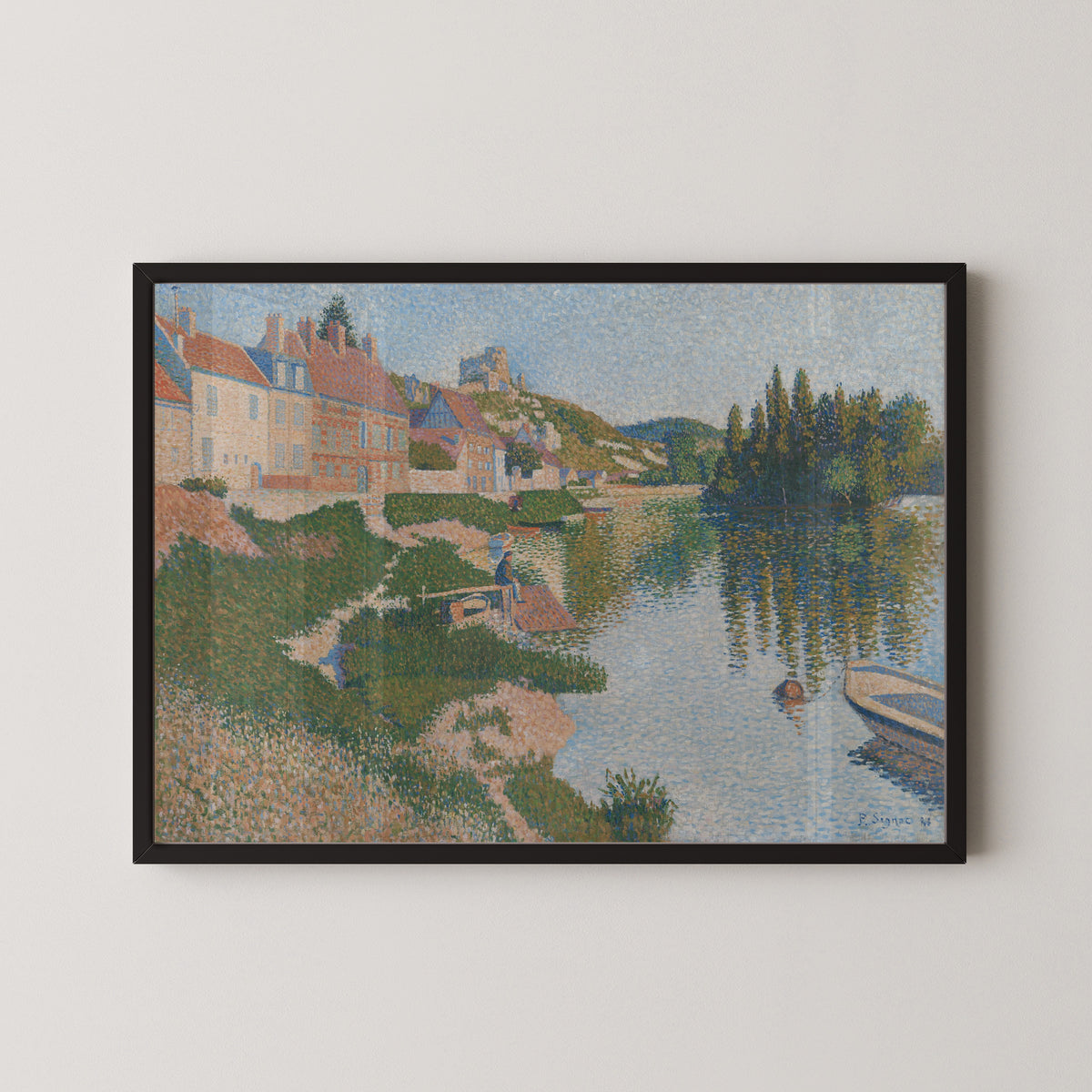Framed art print of Les Andelys (1886) by Paul Signac, in a black frame on a pale wall