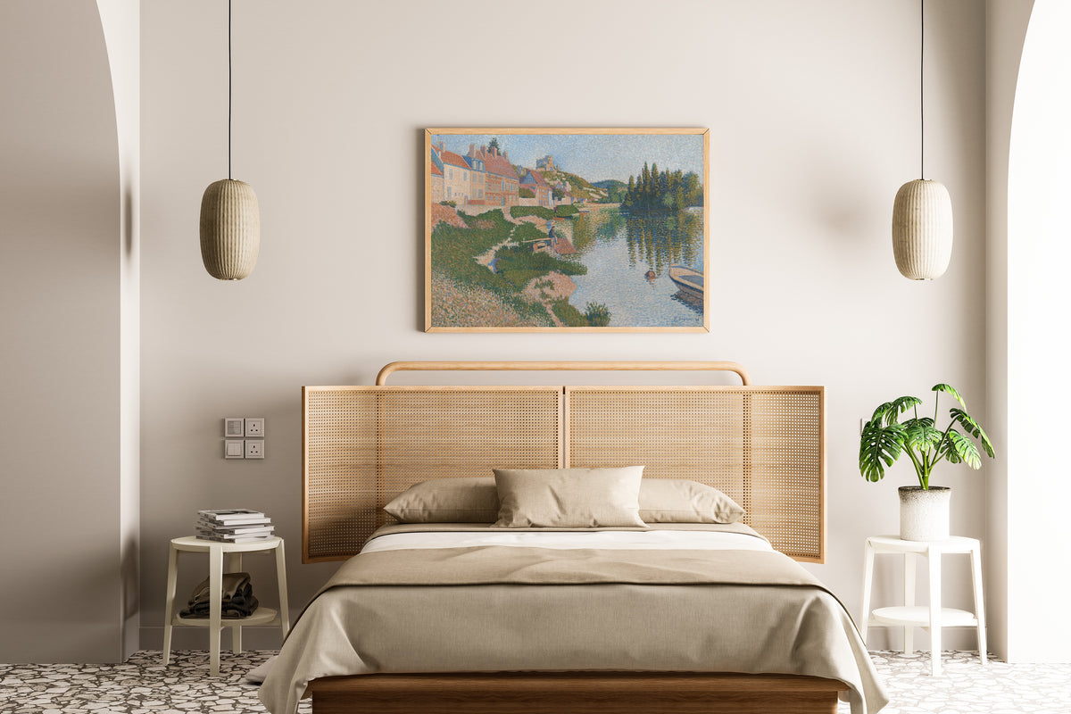 Framed art print of Les Andelys (1886) by Paul Signac, above a cane-headboard bed