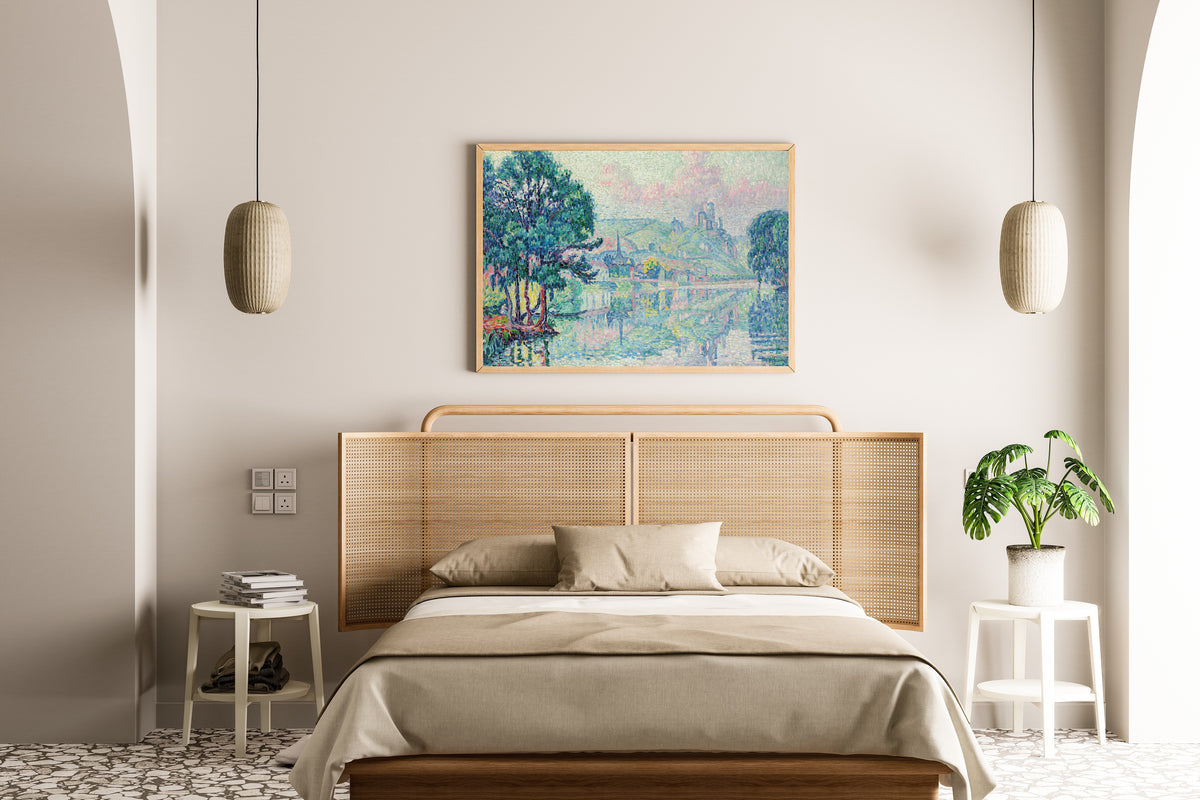 Framed art print of Les Andelys, Morning, Summer by Paul Signac, above a cane-headboard bed