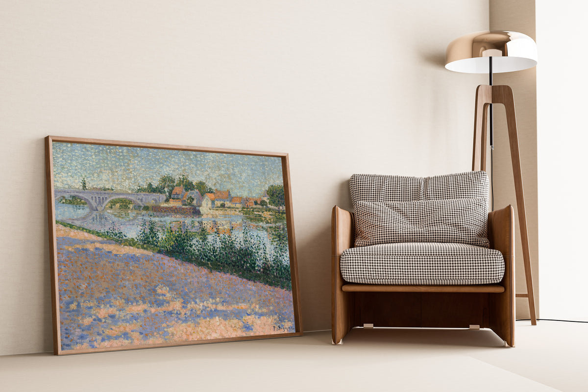 Framed art print of Les Andelys, Port Morin by Paul Signac, leaning against a wall beside an armchair and a floor lamp