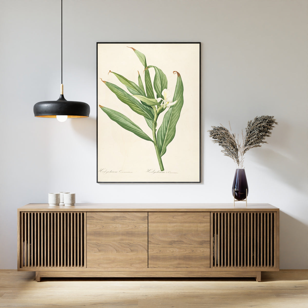 Framed art print of Les Liliacées, Plate 16: Hedychium Coronarium by Pierre-Joseph Redouté, above a slatted wood sideboard