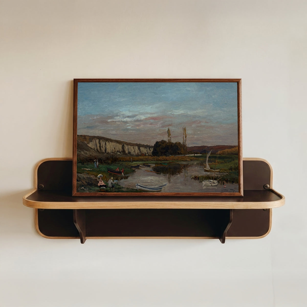 Framed art print of Les Rochers des Grands Malades by Félicien Rops, in a dark wood frame resting on a wall shelf