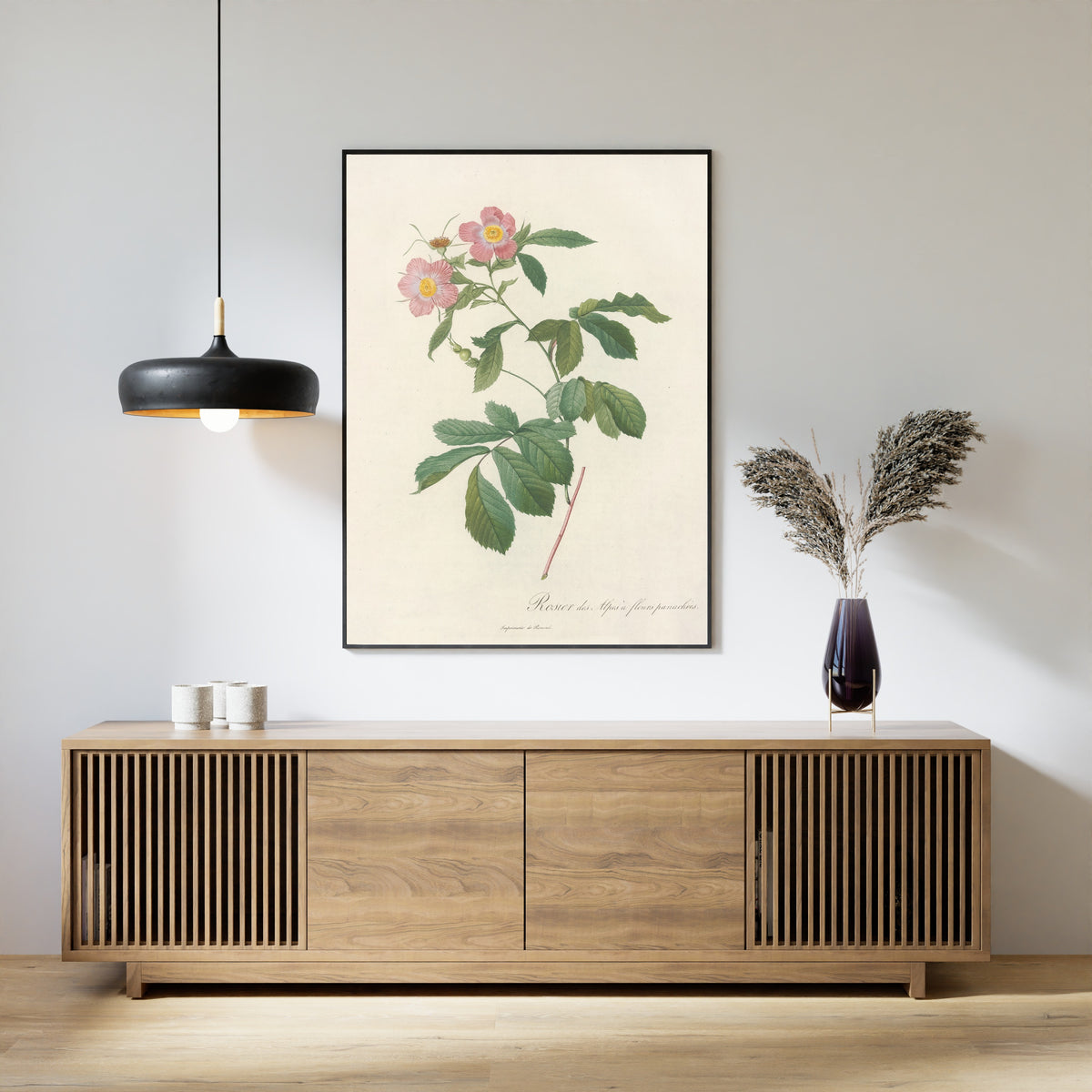 Framed art print of Les Roses: Rosa Alpina Flore Variegato by Pierre-Joseph Redouté, above a slatted wood sideboard