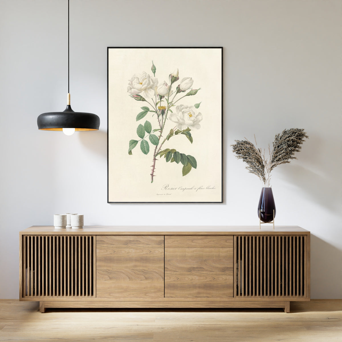 Framed art print of Les Roses: Rosa Campanulata Alba by Pierre-Joseph Redouté, above a slatted wood sideboard
