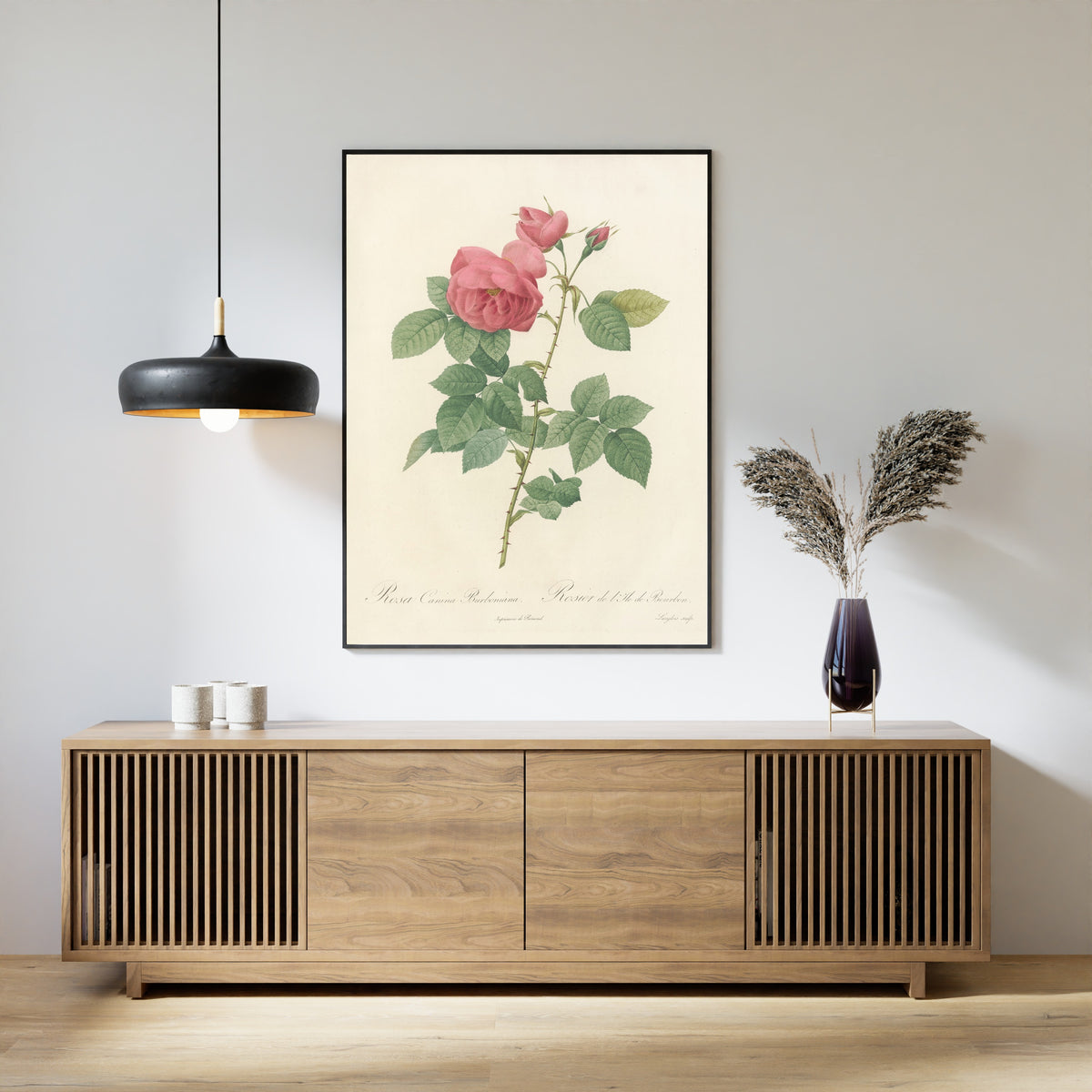 Framed art print of Les Roses: Rosa Canina Burboniana by Pierre-Joseph Redouté, above a slatted wood sideboard
