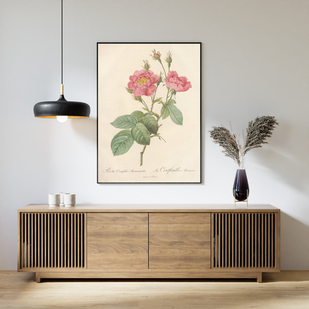 Framed art print of Les Roses: Rosa Centifolia Anemonoides by Pierre-Joseph Redouté, above a slatted wood sideboard