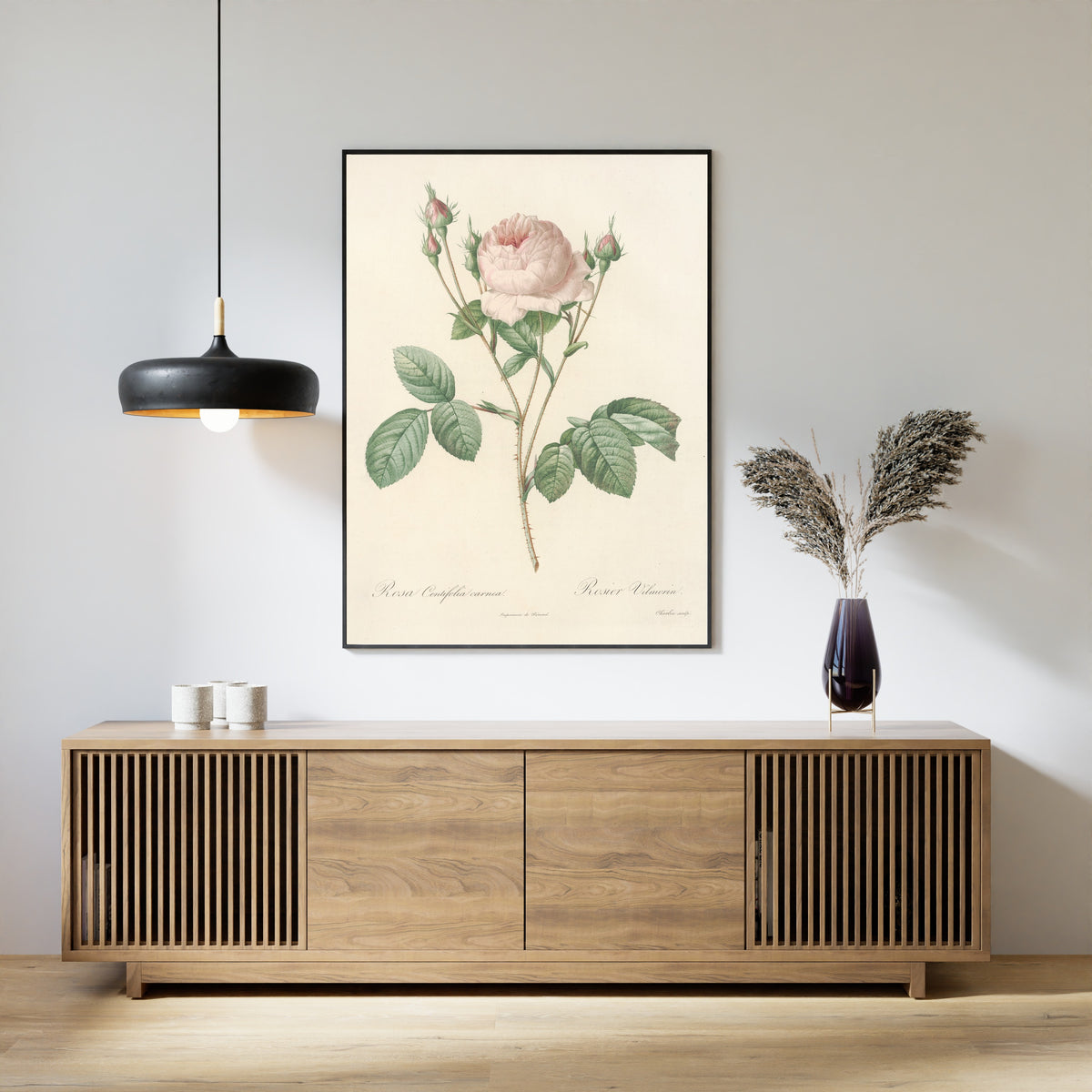 Framed art print of Les Roses: Rosa Centifolia Carnea by Pierre-Joseph Redouté, above a slatted wood sideboard